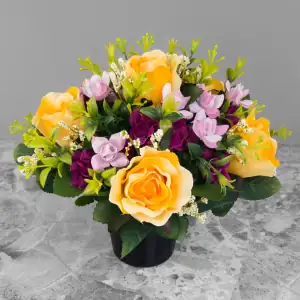 Artificial pale yellow roses, and mauve & pink mini-roses, with gyp and greenery in a full black plastic grave flower pot.