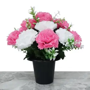 Artificial pink & white carnations, with gyp and greenery in a full black plastic grave flower pot.