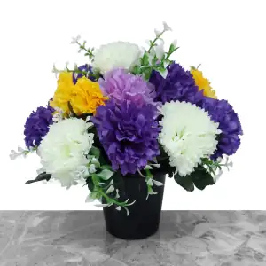 Artificial lilac, purple, yellow & honeydew carnations, with gyp and greenery in a full black plastic grave flower pot.